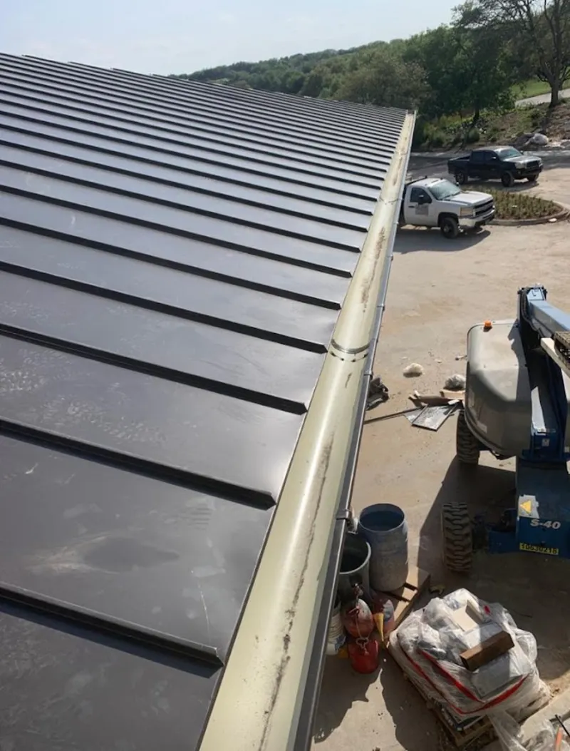 Standing seam panel and gutter detail on a metal roofing jobsite in South San Gabriel